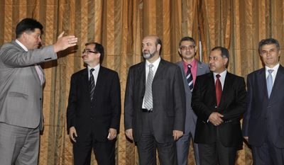 Mikhail Margelov (left), the Kremlin&#39;s Mideast envoy, welcomes a Syrian opposition delegation led by Washington-based rights activist Radwan Ziadeh (second from left) and Mulham Al-Droubi (third from left), one of the leaders of Syria&#39;s Muslim Brotherhood, prior to a meeting in Moscow on June 28, 2011. (Associated Press)
