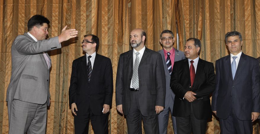 Mikhail Margelov (left), the Kremlin's Mideast envoy, welcomes a Syrian opposition delegation led by Washington-based rights activist Radwan Ziadeh (second from left) and Mulham Al-Droubi (third from left), one of the leaders of Syria's Muslim Brotherhood, prior to a meeting in Moscow on June 28, 2011. (Associated Press)