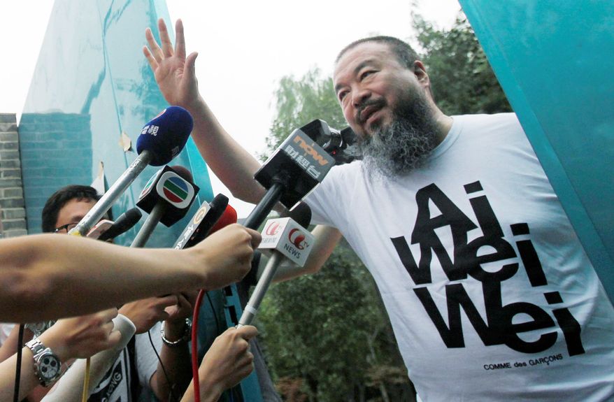 ASSOCIATED PRESS
Activist and artist Ai Weiwei talks to journalists gathered outside his home in Beijing on June 23 after his release from government detention. He is challenging tax evasion charges and a $1.85 million tax bill. Chinese authorities previously have said Mr. Ai was released after he confessed to tax evasion and pledged to repay the money owed.