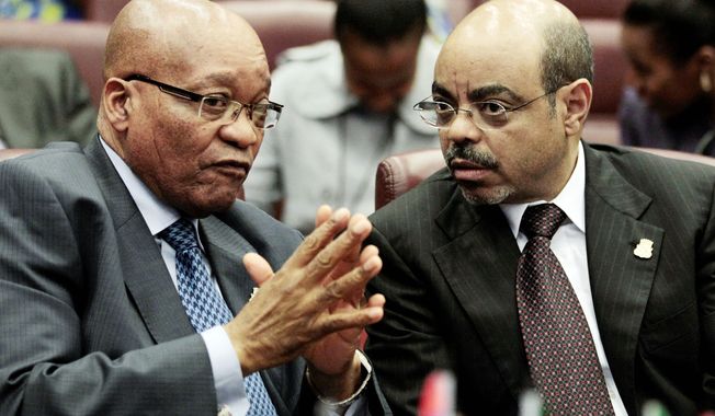 **FILE** South African President Jacob Zuma (left) and Ethiopian Prime Minister Meles Zenawi converse before a summit session.