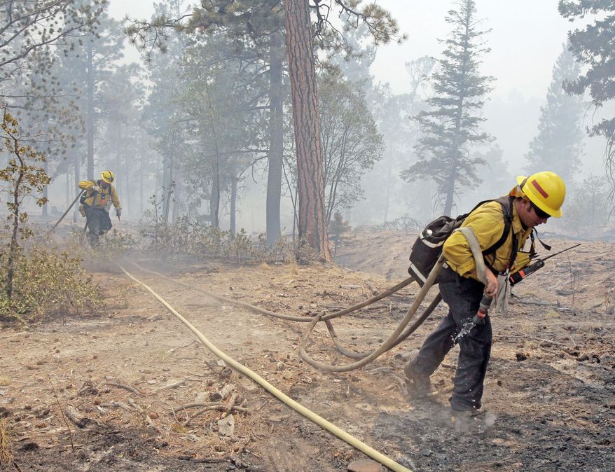 ASSOCIATED PRESS
Firefighters from Apple Valley, Calif., battle the Las Conchas fire near Los Alamos, N.M., on Wednesday. The blaze had grown to more than 108 square miles by Wednesday morning, but it was being held back from the southern boundary of the Los Alamos National Laboratory and its above-ground storage area.