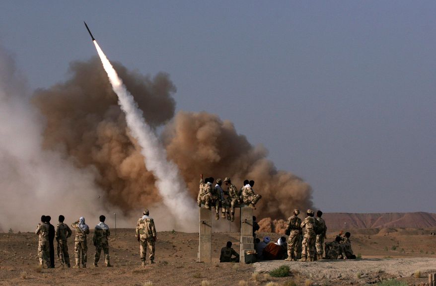 **FILE** Iranian Revolutionary Guard personnel watch the launch of a Zelzal missile during military maneuvers near Qom on June 28, 2011. (Mehr News Agency via Associated Press)