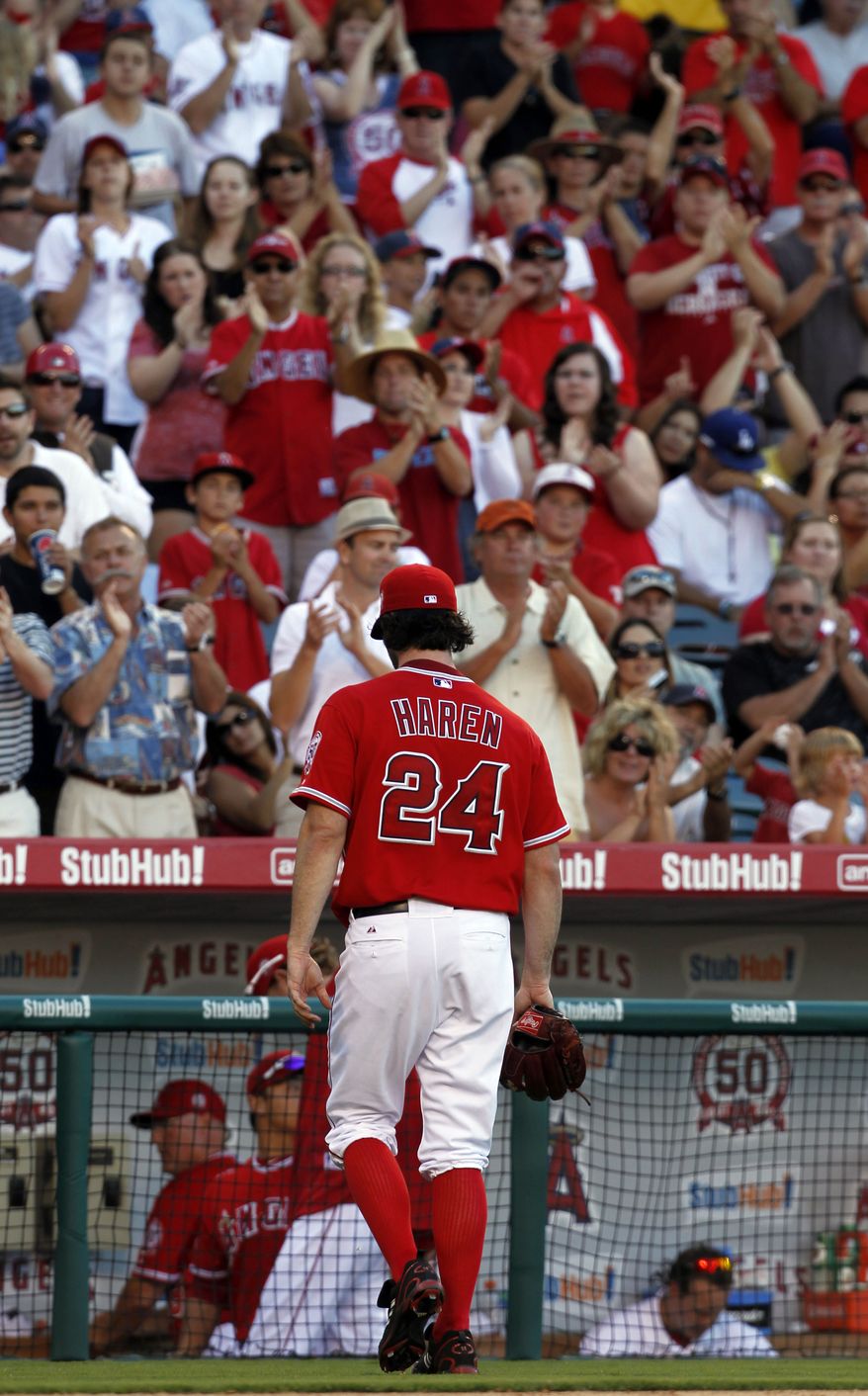 **FILE** Fans applaud for Los Angeles Angels pitcher Dan Haren (24) in the eighth inning as he leaves the game. The Angels won 1-0 and Haren allowed two hits in 7 1/3 innings and struck out six. (Associated Press)