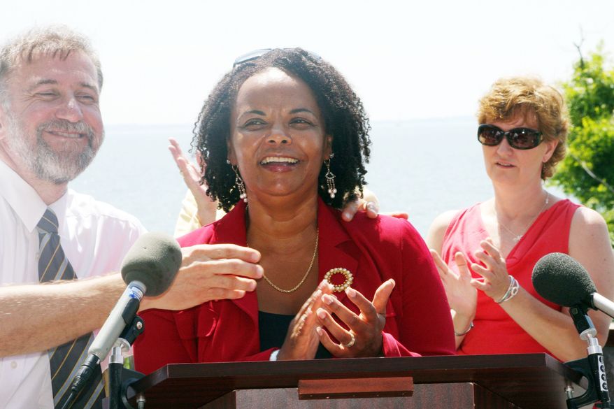 Maryland state Sen. Verna Jones-Rodwell, Baltimore Democrat who sponsored the bill to increase the tax on alcohol, cheers with supporters of the 50 percent jump on Thursday near Annapolis. It is expected to generate $85 million in its first year of implementation. Vincent DeMarco, president of the Maryland Health Care for All Coalition, is at left. Laura Carr, a volunteer with End the Wait Now, is standing to the right. (Associated Press)