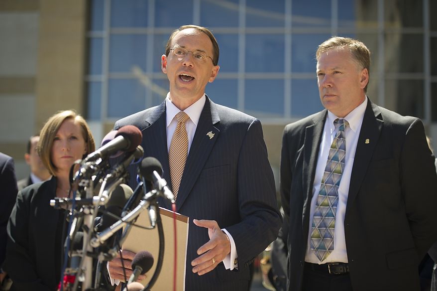 U.S. Attorney for the District of Maryland Rod J. Rosenstein (center) is flanked by Internal Revenue Service-Criminal Investigation Acting Special Agent in Charge, Jeannine A. Hammett (left) and FBI Special Agent in Charge Richard A. McFeely (right) as he makes a statement to reporters to announce that Prince George's County Councilwoman Leslie Johnson, 59, wife of former Prince George's County Executive Jack Johnson, pleaded guilty to the charge of conspiring to obstruct a federal corruption investigation, at the U.S. District Court in Greenbelt, Md., Thursday, June 30, 2011. (Rod Lamkey Jr/The Washington Times)