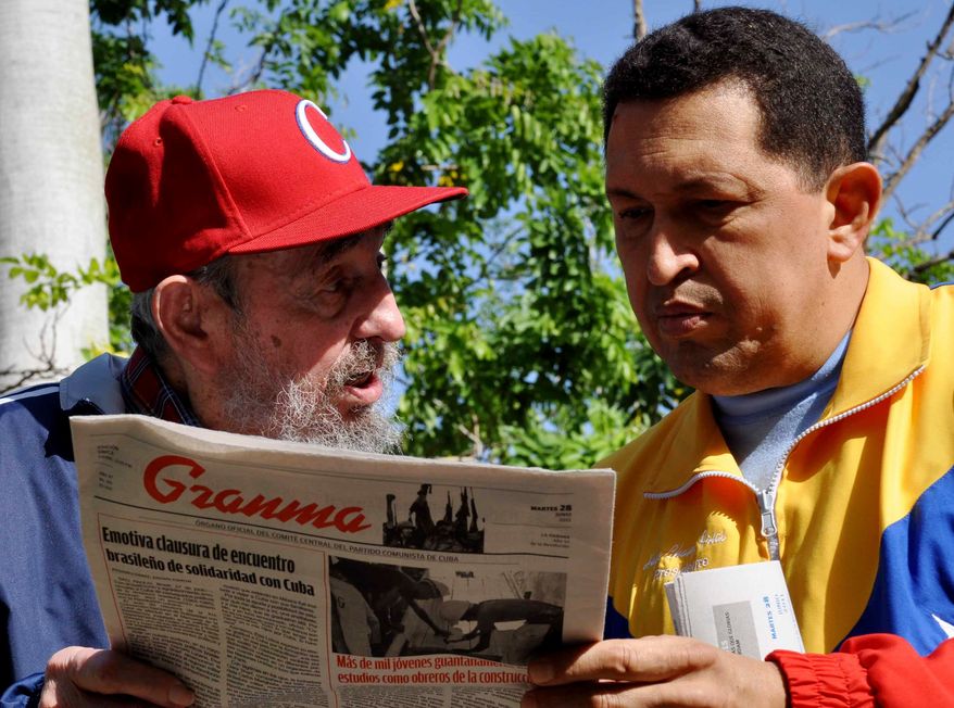 In this photo released by Granma newspaper, Cuba's Fidel Castro, left, and Venezuela's President Hugo Chavez look at Granma state newspaper in an unknown location in Havana, Cuba, on Tuesday, June 28, 2011. (AP Photo/Granma)