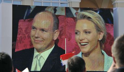 Charlene Wittstock and Prince Albert II of Monaco are seen on a giant screen outside the Monaco palace, Friday, July 1, 2011, during their civil wedding marriage ceremony. (AP Photo/Bruno Bebert, Pool)