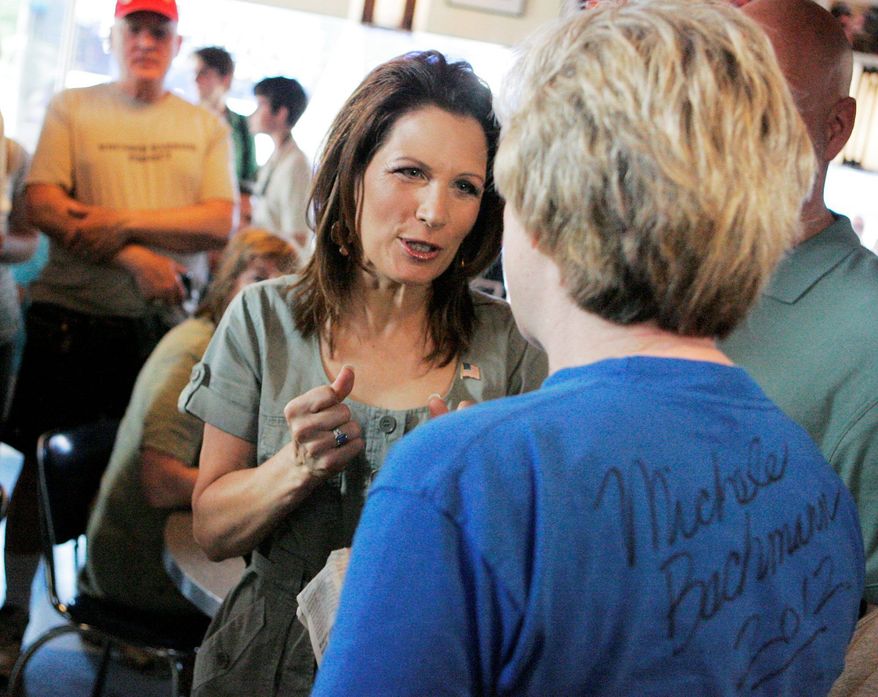 Republican presidential candidate Michele Bachmann (left) speaks with Sheila Reiland of Iowa City, Iowa, during a breakfast chat at the Bluebird Diner on Saturday in Iowa City. The event kicked off Bachmann's Iowa Bus Tour. (Associated Press)