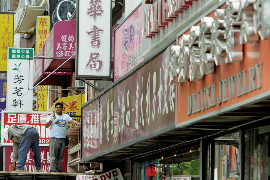 Signs primarily in languages other than English are displayed in the Flushing, Queens, section of New York City. City Council members are wading into a potential culture clash with a bill that would require 60 percent of a business's exterior signage to be in English. (Associated Press)