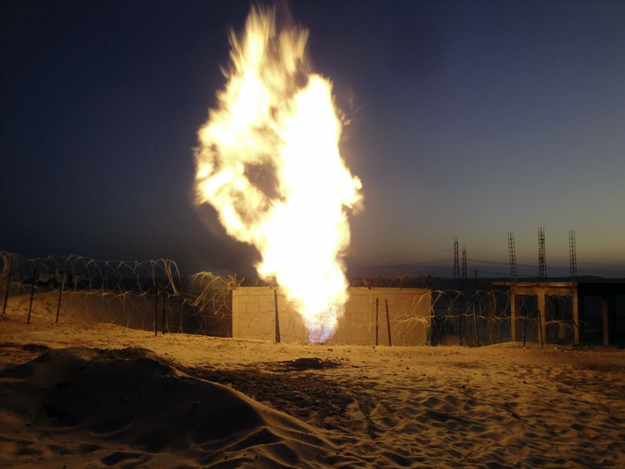 Flames rise near El-Arish, Egypt, 30 miles from the border with Israel, on Monday, July 4, 2011, after unidentified assailants blew up the Egyptian pipeline that carries gas to Israel and Jordan. (AP Photo)
