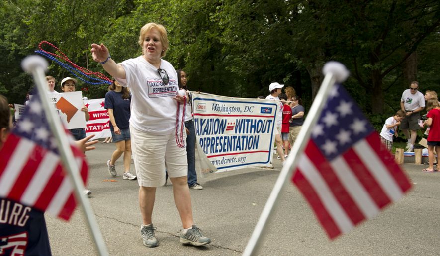Annalee Ash of Washington tosses out red and blue beads to the crowd while marching with the Taxation Without Representation group in the 45th annual Palisades July Fourth parade in Washington on Monday, July 4, 2011. (Barbara L. Salisbury/The Washington Times) ** FILE **