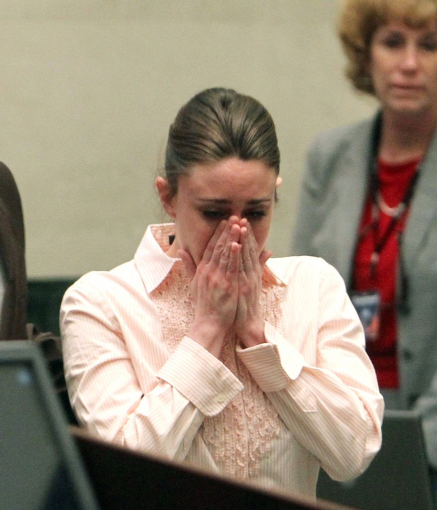 Casey Anthony reacts after the jury acquitted her of murdering her daughter, Caylee, during Anthony's murder trial at the Orange County Courthouse. (AP Photo/Red Huber, Pool)