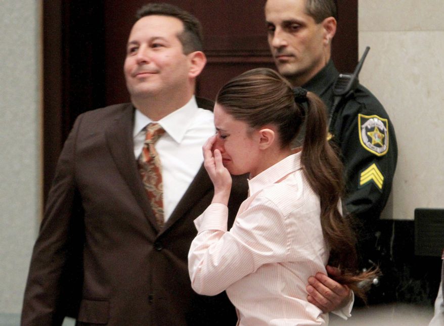 ** FILE ** Defense attorney Jose Baez and Casey Anthony, hug after the jury acquitted her of murdering her daughter, Caylee. (AP Photo/Red Huber, Pool)