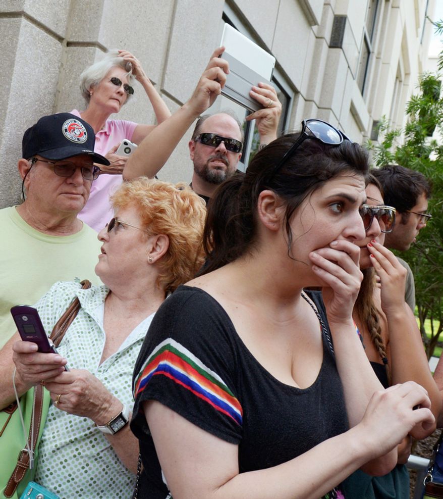Jenn Keller, right, reacts after Casey Anthony's not-guilty verdict was announced outside the Orange County Courthouse. (AP Photo/Phelan M. Ebenhack)