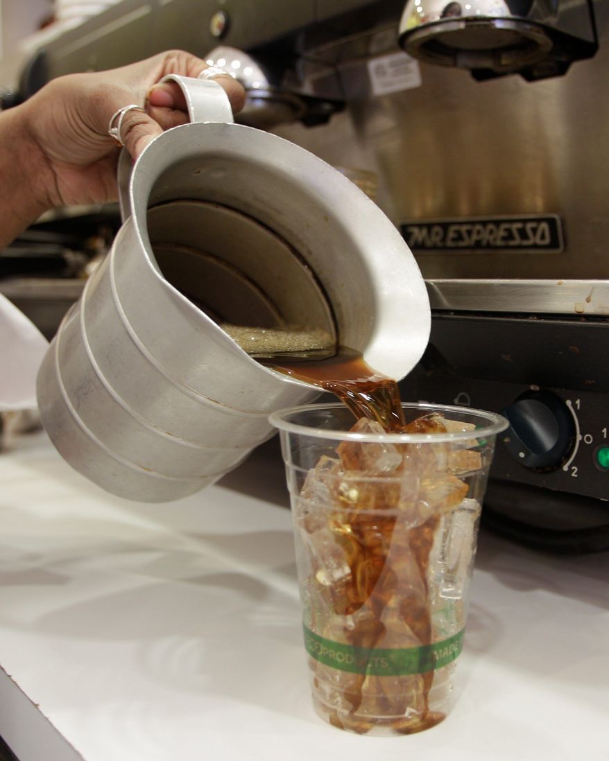 ** FILE ** Sierra Schreiner prepares an iced coffee April 27 at Cafe Madeleine in San Francisco. (Associated Press)