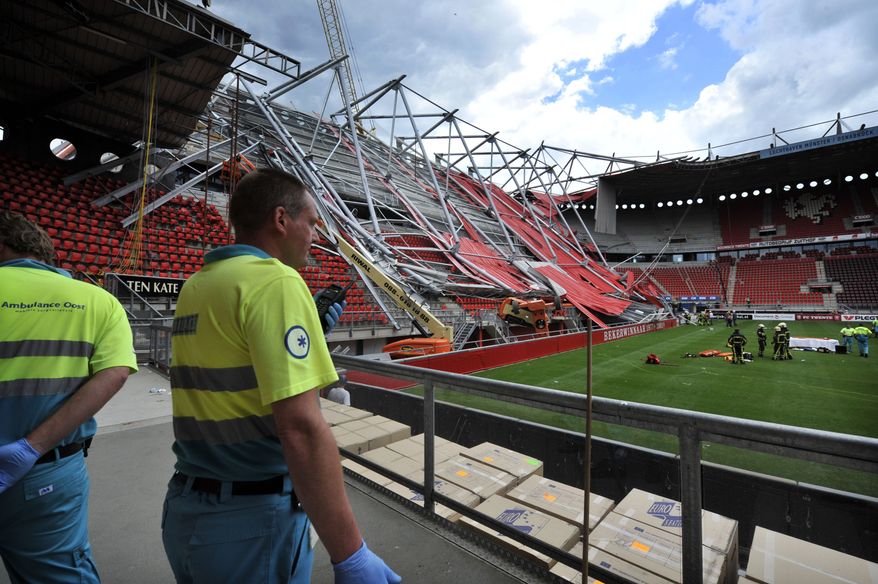 Ambulance workers are seen inside the Grolsch Veste stadium in Enschede, Netherlands, on July 7, 2011. A section of the football stadium collapsed during off-season construction work, trapping people underneath, police said. (Associated Press)
