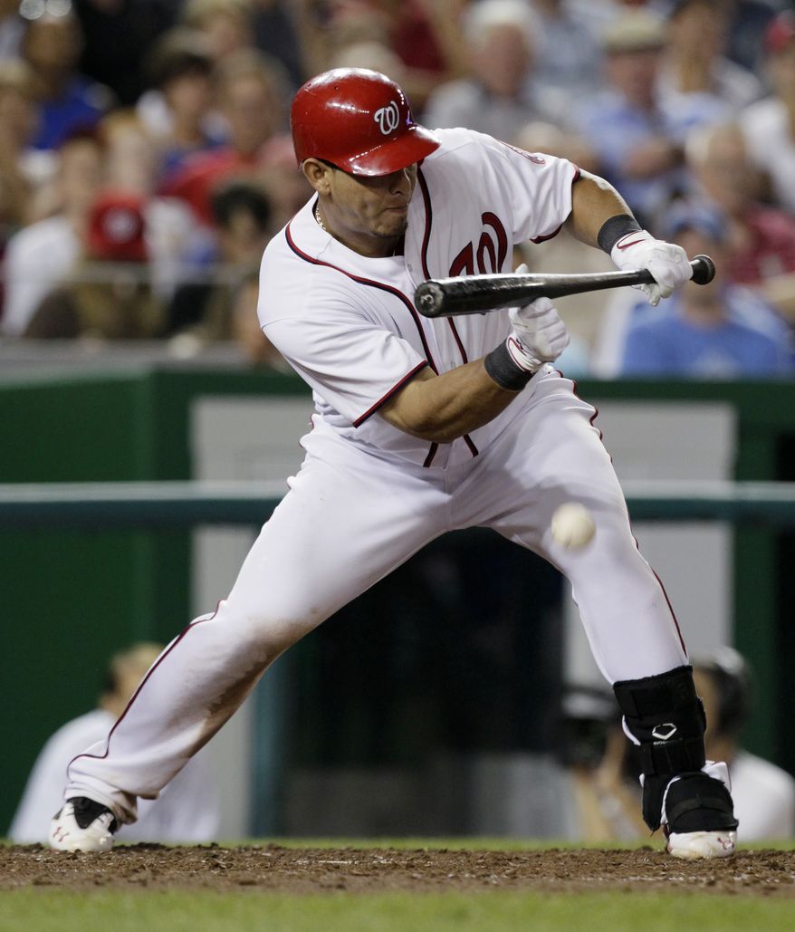 Washington Nationals' Wilson Ramos hits a sacrifice bunt to drive in Washington Nationals' Michael Morse for the ultimate winning run in the seventh inning against the Chicago Cubs at Nationals Park on Wednesday. The Nationals won 5-4. (AP Photo/Carolyn Kaster)