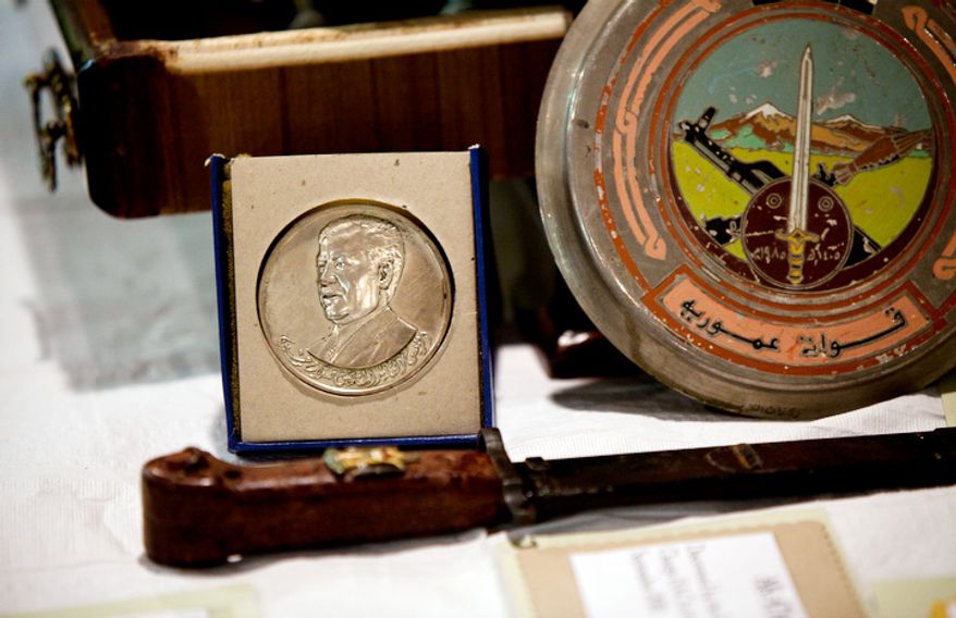 A coin is one of the many artifacts on display during a repatriation ceremony of Iraqi antiquities at the Iraqi Cultural Center in Washington on Thursday, July 7, 2011. (Pratik Shah/The Washington Times)