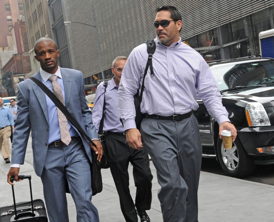 Former Tennessee Titans center and NFL Players Association President Kevin Mowae, right, enters a Manhattan law office, Friday, July 8, 2011, in New York. Members of the NFL Players' Association executive board and owners are meeting in hopes of resolving a lockout that began in March. (AP Photo/ Louis Lanzano)