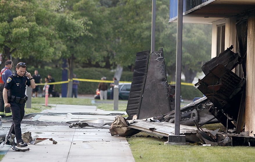 The wreckage of a small plane sticks out of the side of an unoccupied office building at Watsonville Community Hospital on July 7, 2011, in Watsonville, Calif. The plane had just taken off from the Watsonville Municipal Airport. Two people were killed in the crash. (Associated Press/The Sentinel)