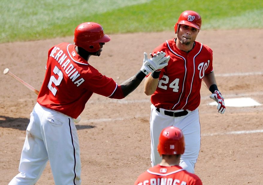Rick Ankiel (24) is congratulated by Roger Bernadina after his eighth-inning pinch-hit homer gave the Nationals breathing room. (Associated Press)