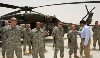 Defense Secretary Leon E. Panetta greets members of the helicopter medivac crew attached to the 115th Combat Support Hospital while making an unannounced visit to Camp Dwyer in southern Afghanistan on Sunday, July 10, 2011. (AP Photo/Paul J. Richards, Pool)
