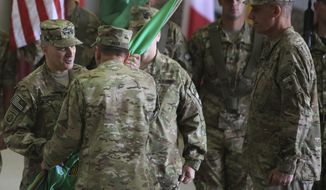 ** FILE ** Lt. Gen. Curtis Scaparrotti (left) receives a flag from Gen. David H. Petraeus (second from left) as Lt. Gen. David M. Rodriguez (right) looks on during a change of command ceremony in Kabul, Afghanistan, on Monday, July 11, 2011. (AP Photo/Rafiq Maqbool)