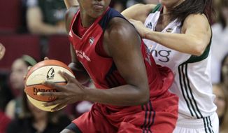 Washington Mystics&#39; Crystal Langhorne, left, tries to put a move on Seattle Storm&#39;s Sue Bird in the first half of a WNBA basketball game Tuesday, July 12, 2011, in Seattle. The Storm won 79-71. (AP Photo/Elaine Thompson)