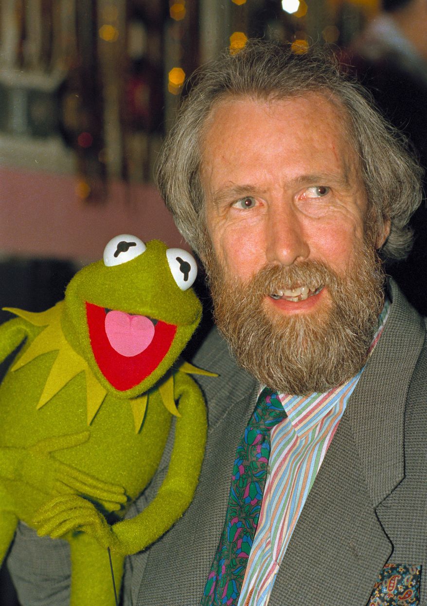 ** FILE ** In this February 1988 photo Jim Henson, creator of the Muppets, poses with one of his creations, Kermit the Frog. A touring exhibit, "Jim Henson's Fantastic World," opening Saturday, July 16, 2011, is making its last stop of a multi-year trip at the Museum of the Moving Image in Queens, New York where it will be on display into January. (AP Photo/file)