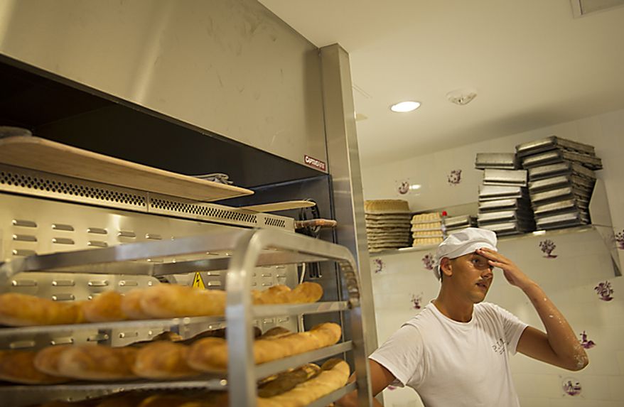 Baker Malik Ayed takes a break at Paul Bakery while baking loaves of baguettes in Washington, D.C., Thursday, July 14, 2011. Some of these loaves will be used in the Baguette Relay Races, held at the United States Navy Memorial, to honor Bastille Day. (Rod Lamkey Jr/The Washington Times)