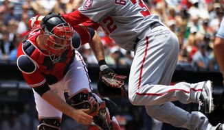 The Nationals&#39; Tom Gorzelanny scores on Roger Bernadina&#39;s triple in the second inning, but the left-hander sprained his right ankle on the play and is listed as day to day. (Associated Press)
