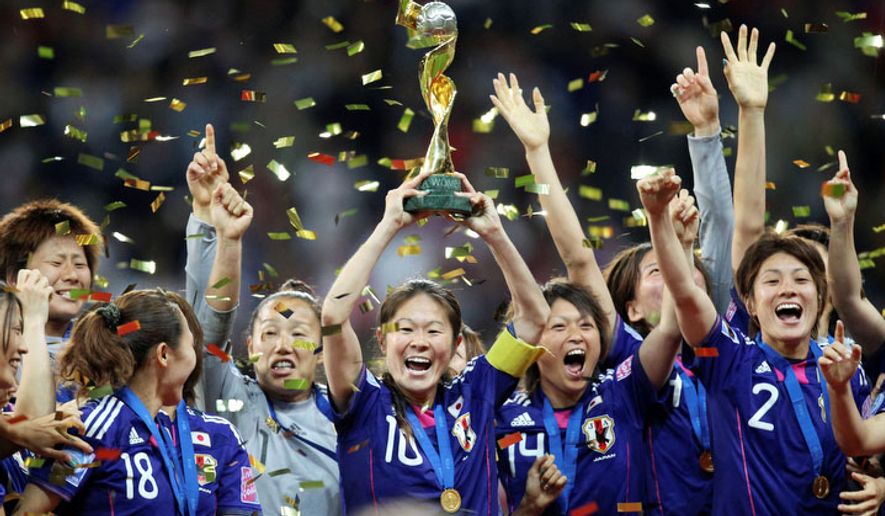 Japanese soccer players celebrate with the trophy after winning their first Women&#39;s World Cup on Sunday, July 17, 2011, in Frankfurt, Germany, after defeating the United States in a penalty shootout. (AP Photo/Michael Probst)