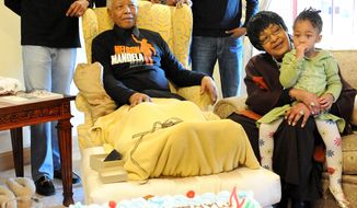 Former South African president Nelson Mandela (front left), his former wife Winnie Madikizela-Mandela (second from right) and other extended family members celebrate Mandela&#39;s 93rd birthday in his hometown of Qunu, South Africa, on July 18, 2011. (Associated Press/Peter Morey Photographic)
