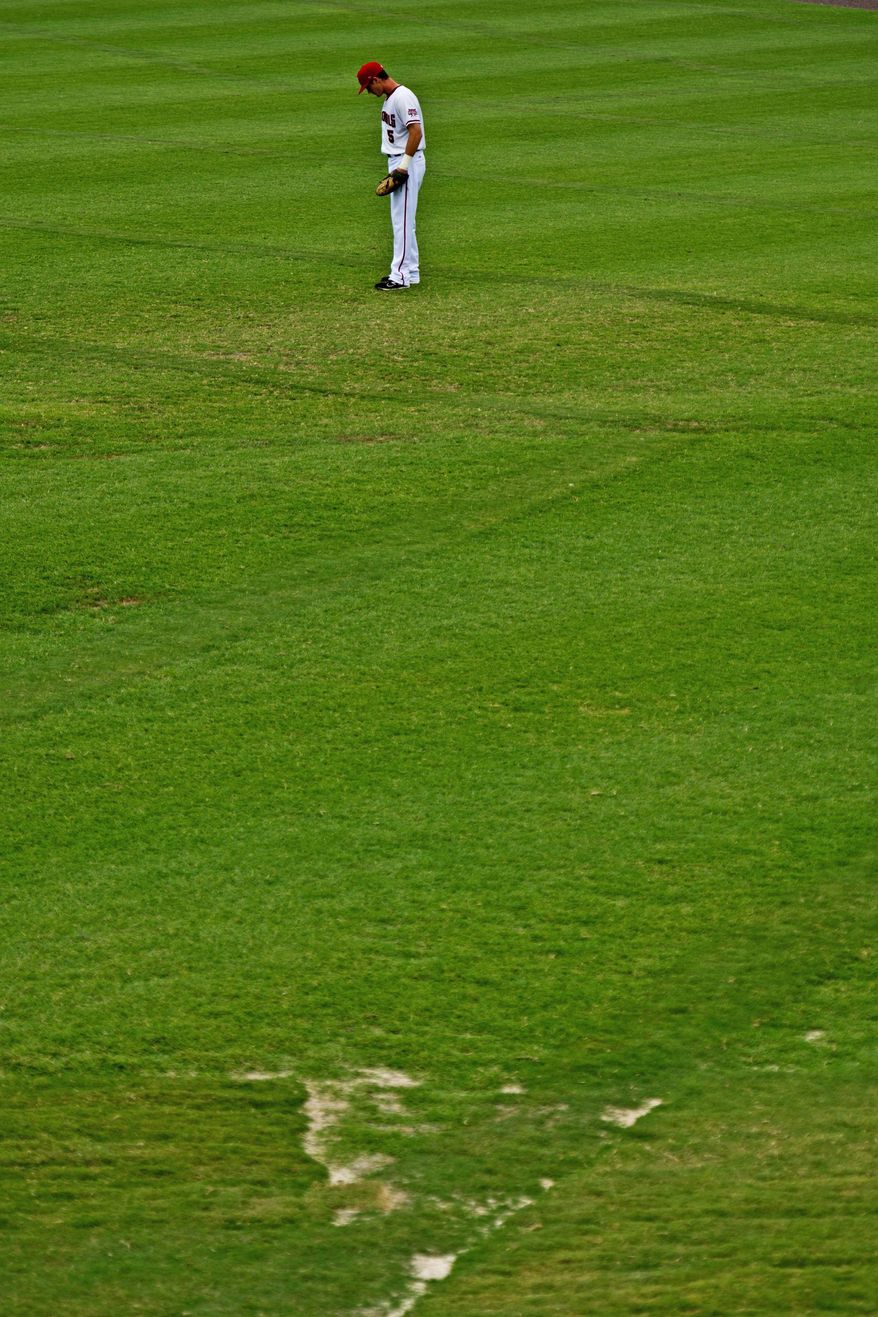 Potomac Nationals outfielder J.R. Higley mans right field at Pfitzner Stadium in Woodbridge, Va., where there are bald spots in the grass. Too much water also has been problematic this season. (Drew Angerer/The Washington Times)