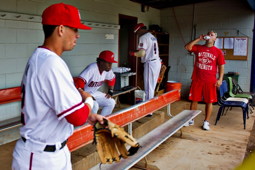 Potomac Nationals players mill about in the small dugout at Pfitzner Stadium, prior to taking the field for a game against the Lynchburg Hillcats, in Woodbridge, Va., Tuesday, July 19, 2011. (Drew Angerer/The Washington Times)