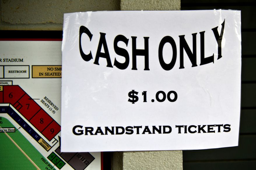 A cash only sign is taped to the ticket booth at Pfitzner Stadium, during a game between the Potomac Nationals and Lynchburg Hillcats, in Woodbridge, Va., Tuesday, July 19, 2011. (Drew Angerer/The Washington Times)