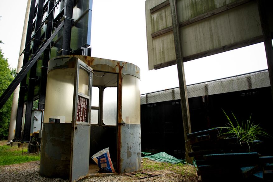 An old rusted out ticket booth is seen behind the outfield wall at Pfitzner Stadium, in Woodbridge, Va., Tuesday, July 19, 2011.(Drew Angerer/The Washington Times)