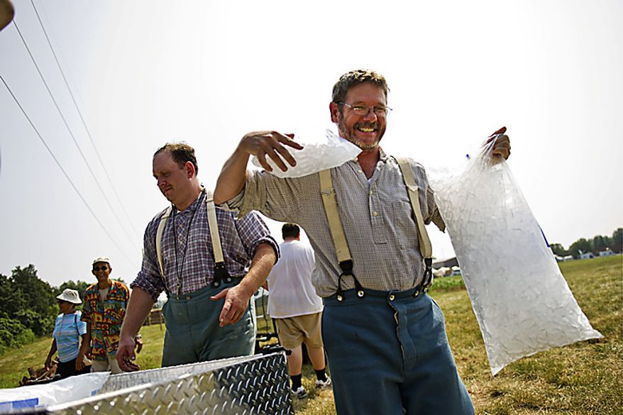 David Keck, of Allentown, Penn., carries bags of ice back to his encampment at Camp Manassas near Jennie Dean Elementary School, in Manassas, Va., Thursday, July 21, 2011. Keck and his group of friends are celebrating the 150th anniversary of the First Battle of Bull Run/Manassas by dressed as a Confederate Artillery Unit and camping out the entire weekend. "Even though it's not authentic, I think if they had bags of ice in the Civil War era, they would have used them," said Keck jokingly, who is wearing wool clothing the entire weekend. (Drew Angerer/The Washington Times)