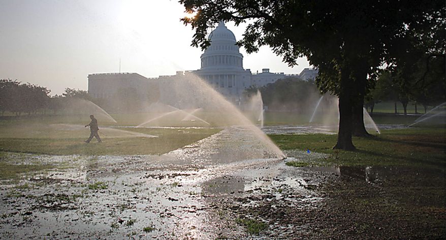 Sprinklers drench the West Lawn of the Capitol ahead of record-high temperatures in Washington, Thursday, July 21, 2011. (AP Photo/J. Scott Applewhite)
