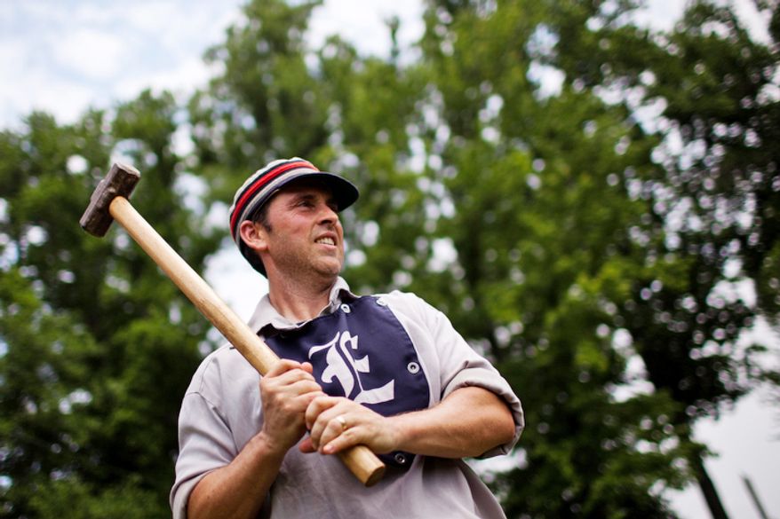 Elkton Eclipse catcher Tim "Ones" Bower, of Rising Sun, Md., warms up on deck with a "hammer" weighted bat during the Loudoun Preservation Society's 19th Century Baseball Day. "It doesn't really help me warm up and it's probably messing up my swing, but it's what they used to use." (Drew Angerer/The Washington Times)