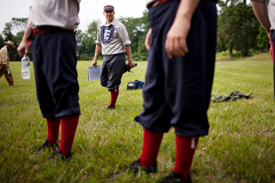 Lee "brew" Donelson of the Elkton Eclipse, center, stretches out before the games started at the Loudoun Preservation Society's 19th Century Baseball Day at the Oatlands, in Leesburg, Va. All the players were their baseball pants baggy and rolled up showing their socks, like players did in the 1860s. (Drew Angerer/The Washington Times)