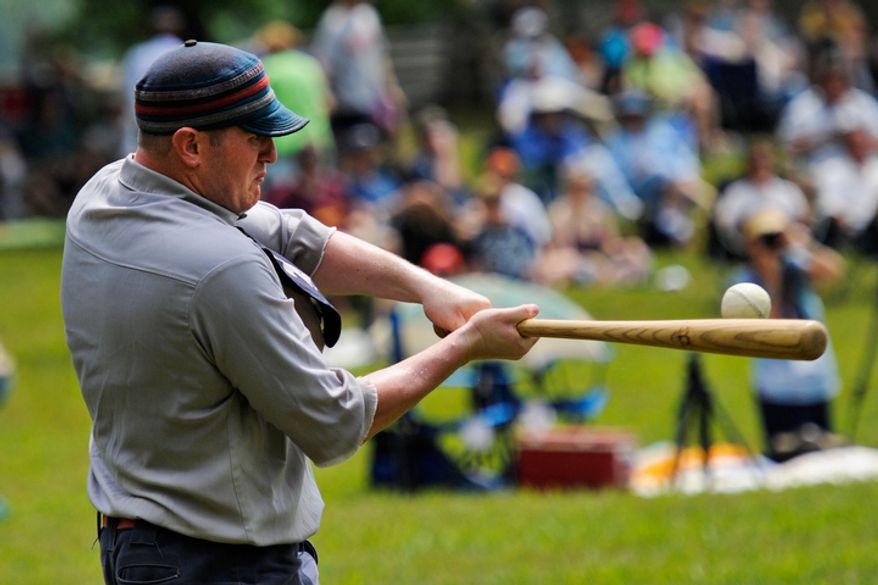 Elkton Eclipse outfielder Glyn "Hammer" Richards, left, of Mt. Ephraim, N.J., hits a pitch during a game during the Loudoun Preservation Society's 19th Century Baseball Day. (Drew Angerer/The Washington Times)