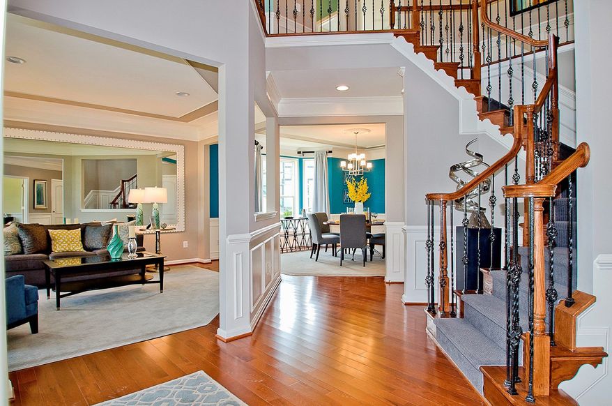 The Avery model features a two-story foyer with a split staircase, which is accessed from the foyer and the family room.