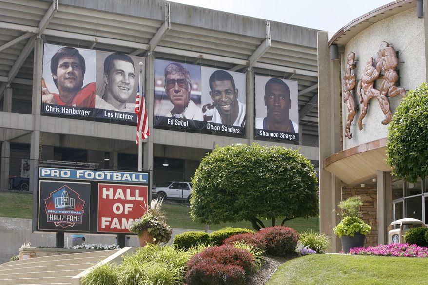 Banners featuring the Class of 2011 hang outside of Fawcett Stadium adjacent to the football museum at the Pro Football Hall of Fame, Friday, July 22, 2011, in Canton, Ohio. Although the NFL announced Thursday, July 21, the cancellation of the annual Hall of Fame Game between the Chicago Bears and the St. Louis Rams, the enshrinement will go ahead as planned. Deion Sanders, Chris Hanburger, Les Richter, Ed Sabol, Shannon Sharpe, Richard Dent, and Marshall Faulk represent the Class of 2011 who will be enshrined on Aug. 6, 2011. (AP Photo/The Repository, Scott Heckel)