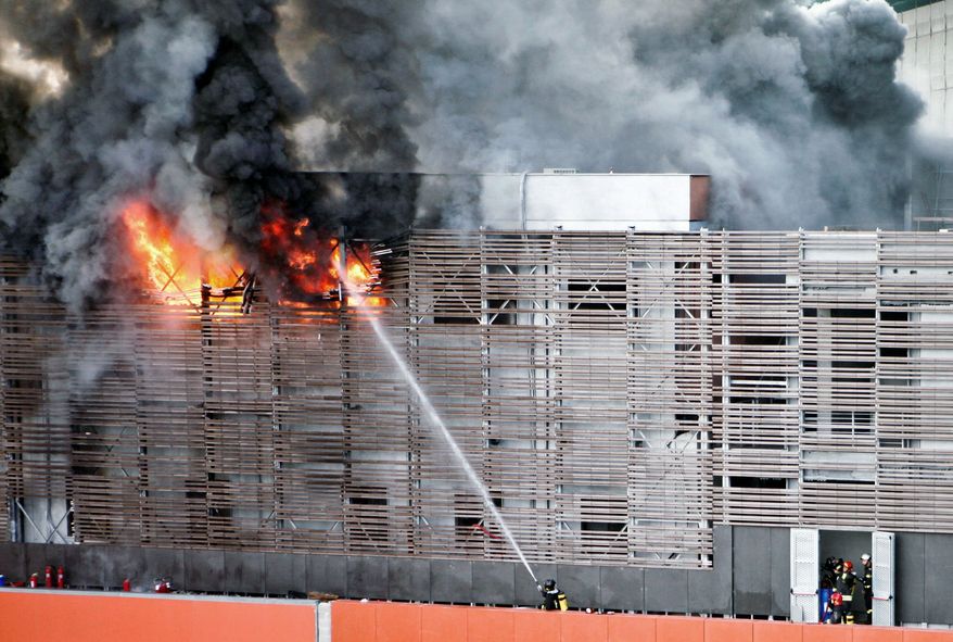 Firefighters try to estinguish flames at Tiburtina station, one of Rome's railway stations, Sunday July 24, 2011. A blaze forced cancellation or long delays for trains along the nation's major north-south routes passing through the capital. (AP Photo/Angelo Corconi)