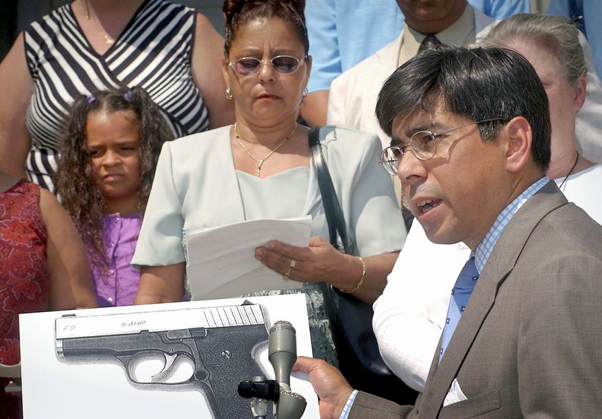 Associated Press
Lawyer Hector Pineiro holds a photograph of a Kahr Arms handgun in Worcester, Mass., at the Aug. 15, 2002, announcement of a lawsuit against the gun maker in connection with the December 1999 fatal shooting of Danny Guzman. A settlement of the case was announced Tuesday.