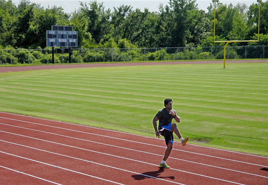 Redskins safety Oshiomogho Atogwe kept in shape by working out at a St. Charles, Mo., high school. Atogwe signed a five-year, $26 million deal in March. (Sid Hastings/Special To The Washington Times)