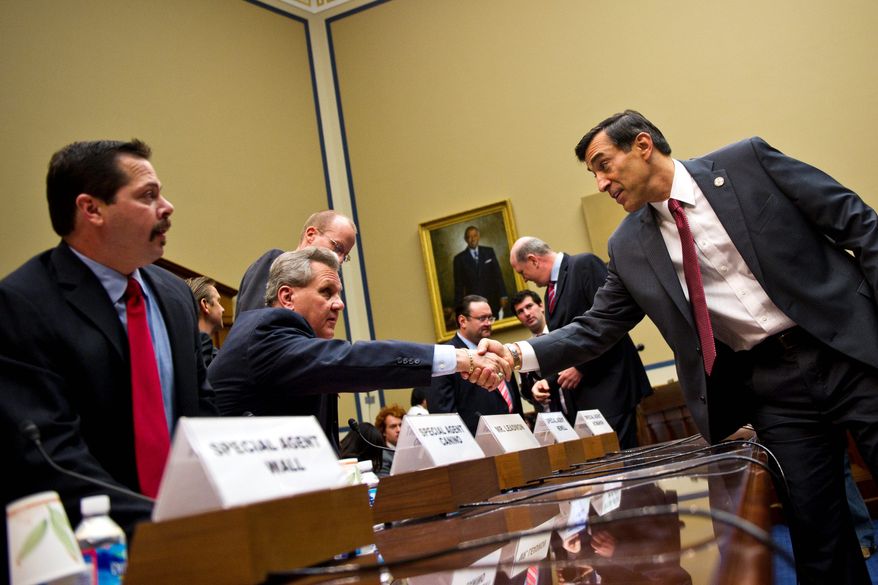 House Oversight and Government Reform Committee Chairman Rep. Darrell E. Issa, California Republican (right), greets Lorren Leadmon, an ATF intelligence operations specialist, before the hearing Tuesday about the fallout from "Operation Fast and Furious." At left is Carlos Canino, ATF acting attache to Mexico.