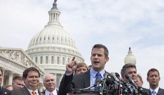 ** FILE ** Rep. Adam Kinzinger (at podium), Illinois Republican, speaks during a July 28, 2011, news conference on Capitol Hill to announce he will vote yes on the GOP plan to raise the debt limit. He is joined by Reps. Blake Farenthold (second from left), Texas Republican; Cory Gardner (second from right), Colorado Republican; and Sean Duffy (right), Wisconsin Republican. (Associated Press)