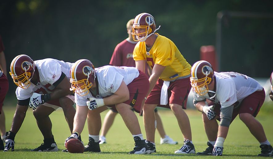 Washington Redskins quarterback John Beck (3) takes the snap while be guarded by Artis Hicks (75) Will Montgomery (63) and Kory Lichtensteiger (78) during the first day of training camp at Redskins Park in Ashburn, Va., Friday, July 29, 2011. (Rod Lamkey Jr./The Washington Times)